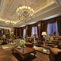 Luxurious Lounge Area With Chandeliers Brown Sofas Coffee Tables And Green Plants
