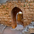 Ancient Stone Ruins With Arched Doorway Steps Pathway And Greenery
