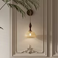 Classic Wooden Wall Lamp With Ribbed Glass Shade On Neutral Wall And Palm Leaves