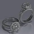 Elegant Diamond Rings With Round Center Stones And Intricate Metal Band Design