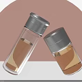 Transparent Glass Cups With Silver Lids And Light Brown Liquid In Pink Gray Background