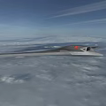 Camouflage Stealth Fighter Jet Flying Through Cloudy Sky With Flying Wing Design