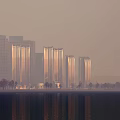 Tall Modern Office Buildings in City with Water Reflection and Foggy Scene