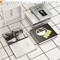 Stacked Books And Open Magazine With Black White Photos Geometric Designs On White Tiled Background
