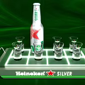 Heineken Silver Bottle With Glasses On Lit Tray And Green Background