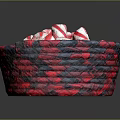 Red and white striped candy arranged in red and black woven basket