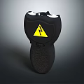 Black Safety Device Featuring Yellow Lightning Warning Symbol And Textured Grip