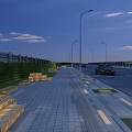 Municipal Road With Street Lamps Paved Sidewalk And Green Belts At Dusk