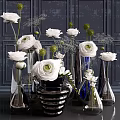 White Floral Arrangement In Black And Blue Glass Vases With Dark Background