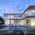 Modern Detached Villa Featuring Large Glass Windows Swimming Pool Outdoor Lounge and Blue Sky View