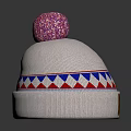 White Knitted Beanie With Pink Pom Pom And Blue Red Geometric Pattern Design