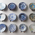 Decorative Plates Wall Display With Blue White And Colorful Patterns On Stands