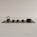 Black Tea Set With Teapot Three Cups And Bowl On Tray Over White Marble Countertop