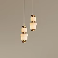Two Pendant Lights With Golden Metal Frames And White Square Shades On Light Colored Wall