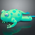 Cartoon Green Frog Toy With Blue Spots On Black Reflective Surface