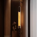 Contemporary Wall Sconce With Vertical Marble Shade And Warm Light On Wooden Wall