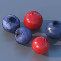 Fresh Red and Blue Berries Filled in a Golden Bowl on Blue Surface