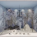 Enchanting Window Display With Blue Background Bare Trees Birdcage Chandelier And Snowy Ground Bench