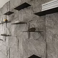 Black Floating Shelves on Grey Stone Wall with Books and Decorative Items
