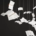 Creative Chandelier With White Book Page Shaped Elements Hanging On Thin Wires Against Black Background