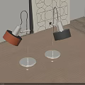 Two Modern Table Lamps With Orange Black Shades Silver Metal Poles On Wooden Table