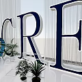 Photo Check In Spot With Giant CRE Letters Green Plants And Modern Seating