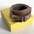 Leather Belts Packaged in Yellow Boxes with Various Colors and Metal Buckles