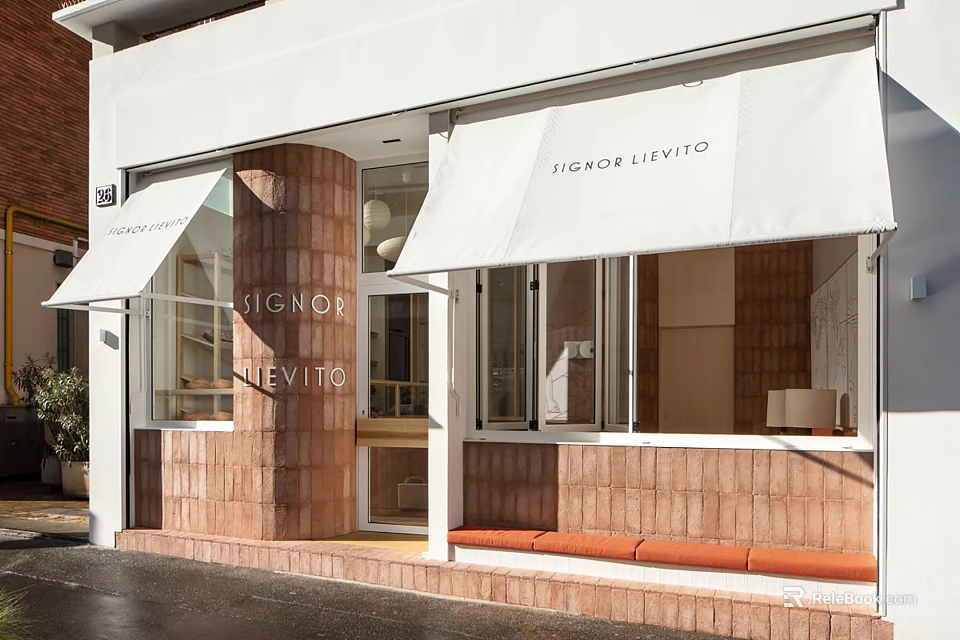 Modern Storefront with White Awning Red Brick Walls Glass Windows and Orange Bench 3d model 