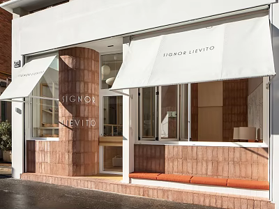 Modern Storefront with White Awning Red Brick Walls Glass Windows and Orange Bench 3d model