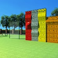 Colorful Outdoor Playground Climbing Wall Equipment With Red Yellow Gray Panels And Green Lawn
