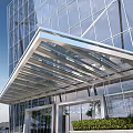 Modern Hotel Building With Glass Facade Stylish Metal Canopy And Landscaped Entrance
