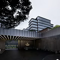 Modern Commercial Complex With Glass Curtain Walls Multi Storey Entrance Canopy Greenery and Landscape Lighting