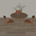 Modern Round Wooden Dining Table With Three Chairs Brown Cushions And Green Plant Decoration