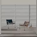 Upholstered Lounge Chairs In Blue And Brown By Window With Small Table And Potted Plant