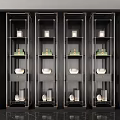 Modern Black and Gold Display Cabinets With Green Boxes White Bowls and Glass Vases