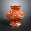 Red Carved Vase Sculpture With Gold Speckles And Textured Surface Design