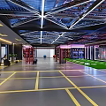 Fitness Center Lounge With Modern Industrial Design Blue Red Pipes Grid Ceiling And Comfortable Sofas
