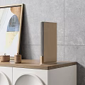 Modern Wooden Speaker Placed on Wooden Countertop with Gray Tile Wall and Decorative Jars