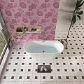 White Bathtub in Bathroom With Pink Floral Wallpaper and Black White Checkered Floor Tiles