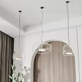 Sleek Modern Interior Three Glass Pendant Lights Gold Accents Arched Doorway Green Plants