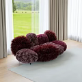 Puffy Burgundy Furry Two Seater Sofa in Room with Large Windows and Green Lawn
