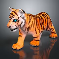 Tiger Cub Toy With Orange Black Stripes And Blue Eyes Standing On Reflective Surface