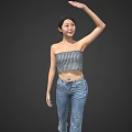 A Woman Wearing Striped Tube Top And Jeans Raising One Arm Against Gray Background