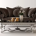 Elegant Brown Sofa with Pillows and Black Coffee Table Set with Silver Legs and Vase