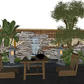 Rockery Stones With Waterfall Bamboo Fence And Plants In Natural Outdoor Garden With Table Chairs