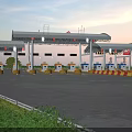 Modern Gas Station With Illuminated Canopy And Petrol Pumps At Evening Time