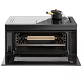 Black Electric Oven With Open Door Visible Interior Baking Tray And Small Pot On Top