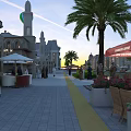 Bustling Shopping Street With Palm Trees Outdoor Restaurant Pedestrians And Hot Air Balloons