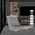 Gray Lounge Chair with Comfortable Design in Modern Interior with Fireplace Flames and Decorative Sculptures