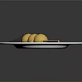 Three Yellow Balls Skewered On Bamboo Stick Served On White Plate With White Sauce